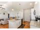 Open kitchen with island, granite counters, and seamless flow to the living area at 173 Silver Tee Ct, Selma, NC 27576