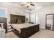 Spacious main bedroom featuring a large dark wood bed frame and modern ceiling fan at 173 Silver Tee Ct, Selma, NC 27576