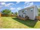 Spacious backyard featuring a deck, green grass, and fenced perimeter at 2 White Spruce Ct, Durham, NC 27703