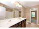 Bright bathroom featuring double sinks, white countertops, and neutral walls at 2 White Spruce Ct, Durham, NC 27703