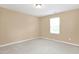 Bedroom featuring neutral carpeting and a window providing natural light at 2 White Spruce Ct, Durham, NC 27703
