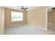 Neutral bedroom with plush carpeting, a ceiling fan, and a window offering natural light at 2 White Spruce Ct, Durham, NC 27703