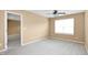 Neutral bedroom with plush carpeting, a ceiling fan, and a window offering natural light at 2 White Spruce Ct, Durham, NC 27703