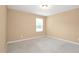 This bedroom features neutral carpeting and a window providing natural light at 2 White Spruce Ct, Durham, NC 27703