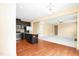 Open concept kitchen with dark cabinetry, stainless steel appliances, and an island flows into living area at 2 White Spruce Ct, Durham, NC 27703