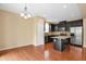 Eat-in kitchen featuring stainless steel appliances, granite countertops, and hardwood floors at 2 White Spruce Ct, Durham, NC 27703