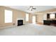 Bright living room with fireplace offering open access to kitchen area with natural light at 2 White Spruce Ct, Durham, NC 27703