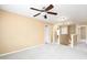 Open loft area with neutral carpet, a ceiling fan, and views of the staircase and hallway at 2 White Spruce Ct, Durham, NC 27703