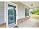 Covered front porch with stone accents and a glass front door at 2 White Spruce Ct, Durham, NC 27703
