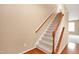 Carpeted staircase with wooden handrail and white spindles at 2 White Spruce Ct, Durham, NC 27703