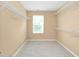 Walk-in closet featuring carpeted floor, shelving, and window for natural light at 2 White Spruce Ct, Durham, NC 27703