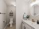 This bright bathroom has a modern sink, shelving, and toilet at 2004 Valley Ridge Ct, Raleigh, NC 27603