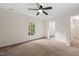 Carpeted bedroom featuring a window, ceiling fan, and ensuite bathroom at 2004 Valley Ridge Ct, Raleigh, NC 27603