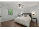 Cozy primary bedroom with a window, ceiling fan, and comfortable carpet flooring at 2004 Valley Ridge Ct, Raleigh, NC 27603