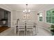 Cozy dining room with a modern chandelier and a view of the backyard at 2004 Valley Ridge Ct, Raleigh, NC 27603