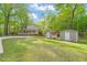 Beautiful home exterior with mature trees and storage sheds at 2004 Valley Ridge Ct, Raleigh, NC 27603