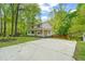 Exterior shot of home with lush trees and a long driveway at 2004 Valley Ridge Ct, Raleigh, NC 27603