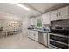 Bright eat-in kitchen boasts stainless appliances, ample cabinet space, and modern tile flooring at 2004 Valley Ridge Ct, Raleigh, NC 27603