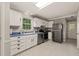 Well-lit kitchen with ample counter space, stainless steel appliances, and classic white cabinetry at 2004 Valley Ridge Ct, Raleigh, NC 27603
