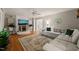 Cozy living room features a stone fireplace, hardwood floors, and a comfortable sectional sofa at 2004 Valley Ridge Ct, Raleigh, NC 27603