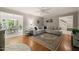 Spacious living room with hardwood floors, a sectional sofa, and a dining area view at 2004 Valley Ridge Ct, Raleigh, NC 27603