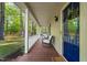 Covered front porch with wooden floors and chairs for outdoor relaxation at 2004 Valley Ridge Ct, Raleigh, NC 27603