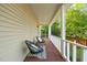 The exterior porch features a wood floor, white columns, and chairs at 2004 Valley Ridge Ct, Raleigh, NC 27603