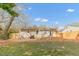 A backyard with a wooden deck, mulch, and a privacy fence, providing a cozy outdoor living space at 2014 Walnut St, Durham, NC 27705