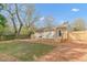 A backyard featuring a wooden deck with seating area, mulch and a privacy fence at 2014 Walnut St, Durham, NC 27705