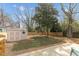 Backyard featuring a storage shed, wooden privacy fence, mature trees, and a wooden deck at 2014 Walnut St, Durham, NC 27705