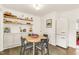 Stylish kitchen with open shelving, updated appliances, and dining table with seating at 2014 Walnut St, Durham, NC 27705