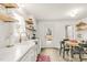 Bright kitchen featuring white cabinetry, open shelving, and a cozy dining area at 2014 Walnut St, Durham, NC 27705