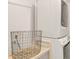 This laundry room features stacked washer and dryer units, and a wire basket on a wood shelf at 2014 Walnut St, Durham, NC 27705