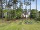 Large backyard with a garden and surrounded by mature trees, offering ample privacy at 207 Ashley Brook Ct, Cary, NC 27513