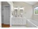 Bright bathroom features double sinks, modern lighting and a large bathtub at 207 Ashley Brook Ct, Cary, NC 27513