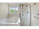 This bathroom features a separate soaking tub and glass door shower stall at 207 Ashley Brook Ct, Cary, NC 27513