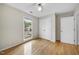 Comfortable bedroom with light hardwood floors, ceiling fan and double door closet at 207 Ashley Brook Ct, Cary, NC 27513