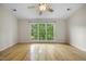 Inviting bedroom with hardwood floors and natural light streaming through the windows at 207 Ashley Brook Ct, Cary, NC 27513