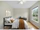 Inviting bedroom featuring a ceiling fan, natural light, and stylish decor at 207 Ashley Brook Ct, Cary, NC 27513