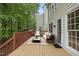 A wood deck features outdoor seating and access to the home's screened-in porch at 207 Ashley Brook Ct, Cary, NC 27513