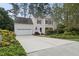 Traditional home features a two-car garage, dormers, red shutters, and a well-manicured lawn at 207 Ashley Brook Ct, Cary, NC 27513