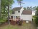 Back exterior featuring a well-maintained lawn, two level deck and beautiful landscaping at 207 Ashley Brook Ct, Cary, NC 27513