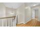 Hallway with hardwood floors, white trim, and a view of the stairwell at 207 Ashley Brook Ct, Cary, NC 27513