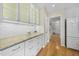 Bright kitchen with white cabinets, granite countertops, and a view to the foyer and living room at 207 Ashley Brook Ct, Cary, NC 27513