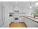 Modern kitchen with white cabinets, stainless steel appliances, and ample counter space at 207 Ashley Brook Ct, Cary, NC 27513