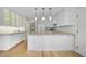 Well-lit kitchen featuring white cabinets, granite countertops, and modern appliances at 207 Ashley Brook Ct, Cary, NC 27513