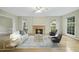 Cozy living room with a marble fireplace and plenty of natural light at 207 Ashley Brook Ct, Cary, NC 27513