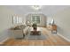 Bright living room with hardwood floors, neutral decor, and a large window for natural light at 207 Ashley Brook Ct, Cary, NC 27513