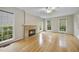 Sun-filled living room showcases a fireplace and multiple windows at 207 Ashley Brook Ct, Cary, NC 27513