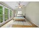 Spacious main bedroom with vaulted ceilings, a ceiling fan and scenic window views at 207 Ashley Brook Ct, Cary, NC 27513
